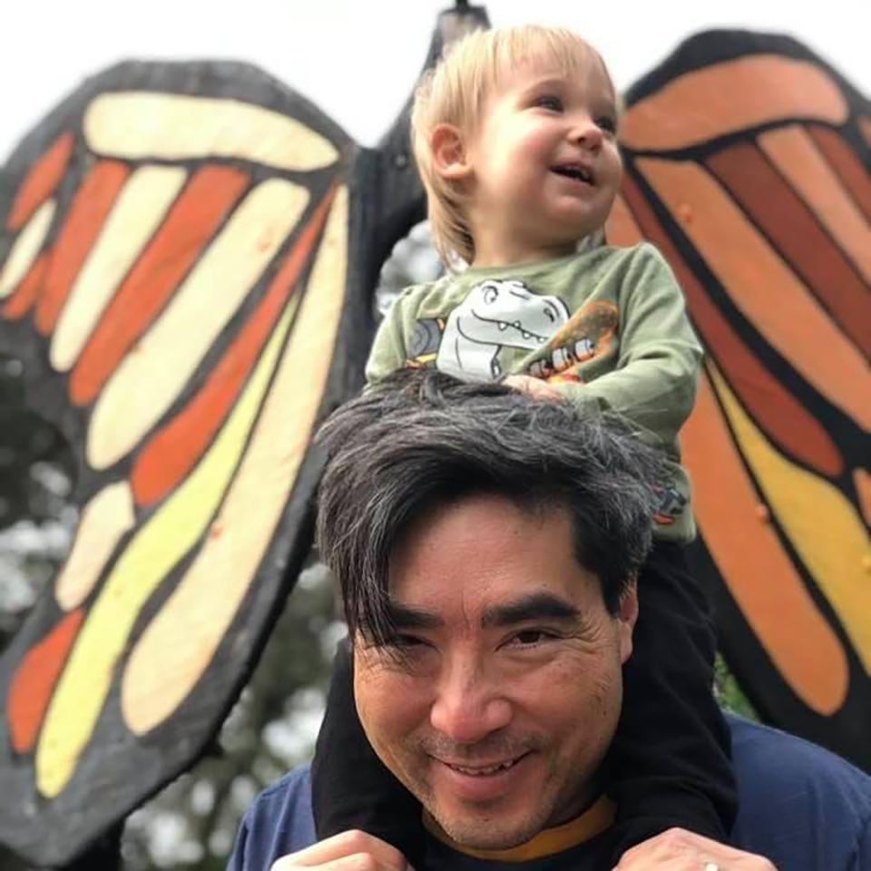 Papa with Sebastian in front of a butterfly sculpture